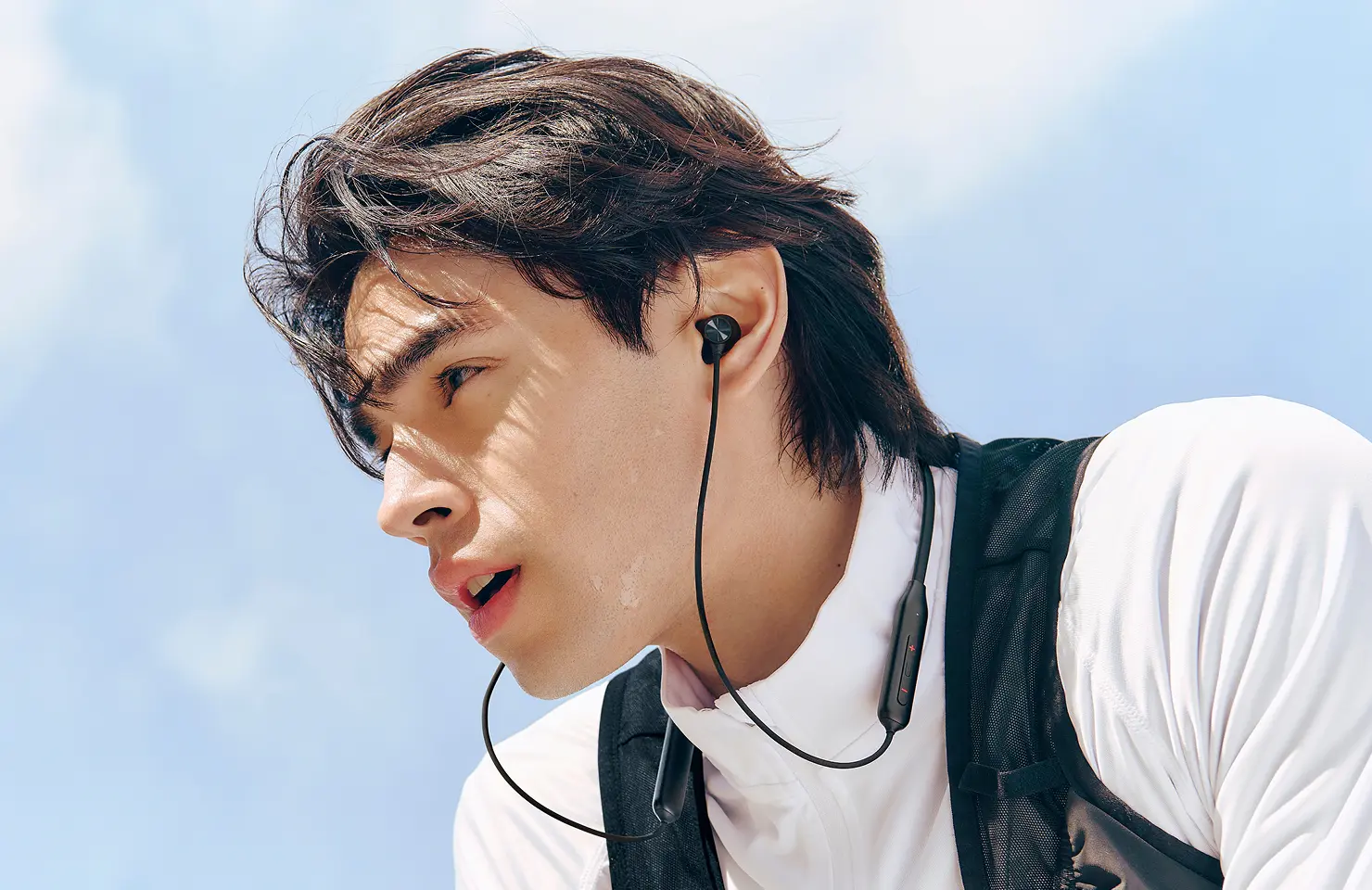 Manufacturer lifestyle image showing the black OnePlus Bullets Wireless Z3 being worn.